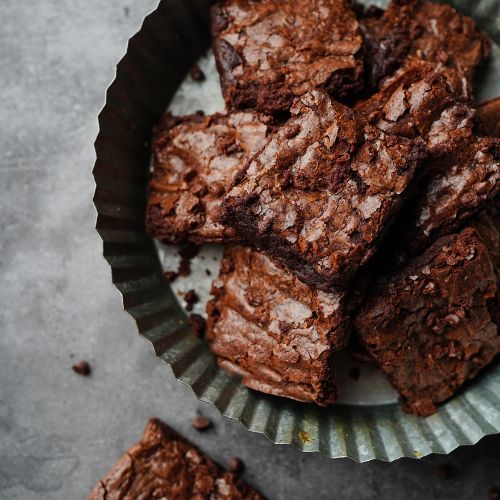 How can I make my brownies more fudgy than cakey?